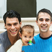 Two boys having a swim with small child 