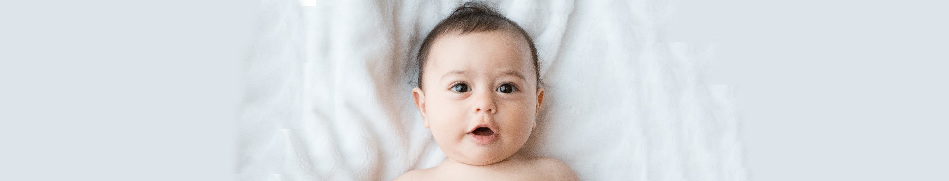 A baby lying on the bed