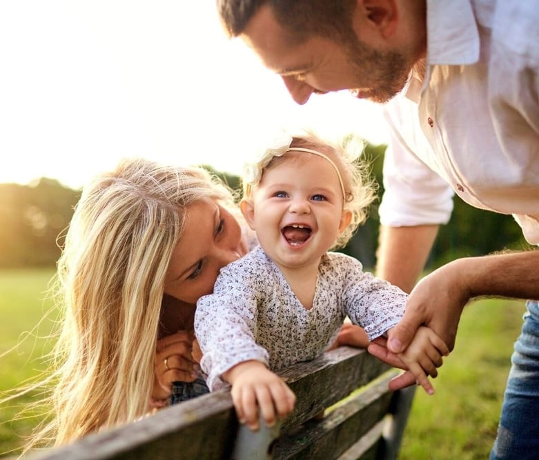 Family Laughing Sitting On Bench in Ontario, Canada